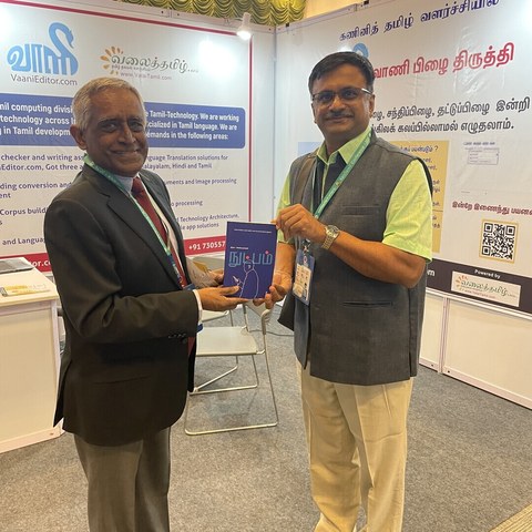 Venkatarangan Thirumalai presenting a copy of Nutpam to Mr Arun Mahizhnan.
